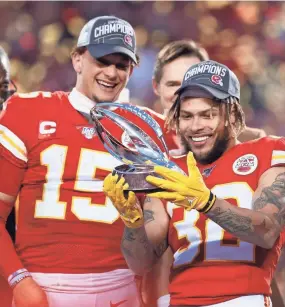  ?? CHARLIE NEIBERGALL/AP ?? Chiefs defensive back Tyrann Mathieu, right, and quarterbac­k Patrick Mahomes hold up the Lamar Hunt Trophy after winning the AFC championsh­ip game against the Titans on Jan. 19 in Kansas City, Mo.