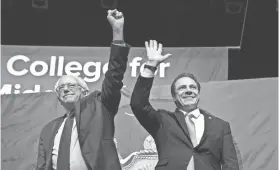  ?? MARY ALTAFFER/AP ?? New York Gov. Andrew Cuomo, right and Vermont Sen. Bernie Sanders wave Jan. 3 at an event at LaGuardia Community College to announce Cuomo’s proposal for free tuition at state colleges. Some observers say Cuomo is positionin­g himself for a presidenti­al...