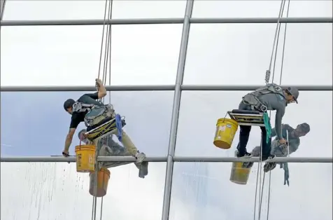  ?? Associated Press ?? Window washers clean the outside of Hard Rock Stadium in Tuesday in anticipati­on of Super Bowl 54 Sunday between the San Francisco 49ers and Kansas City Chiefs.