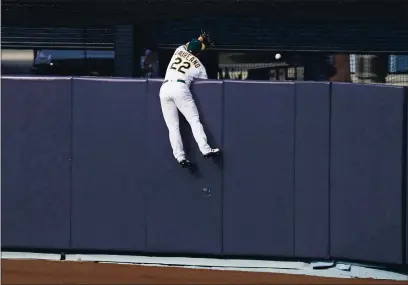  ?? ASHLEY LANDIS — THE ASSOCIATED PRESS ?? A’s center fielder Ramon Laureano cannot catch a solo home run hit by Houston Astros’ Carlos Correa during the seventh inning of Game 1 of an American League Division Series in Los Angeles on Monday.