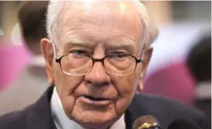  ??  ?? Warren Buffett, CEO of Berkshire Hathaway Inc, talks to a reporter in the exhibit hall at the company’s annual meeting in Omaha, Nebraska. — Reuters photo