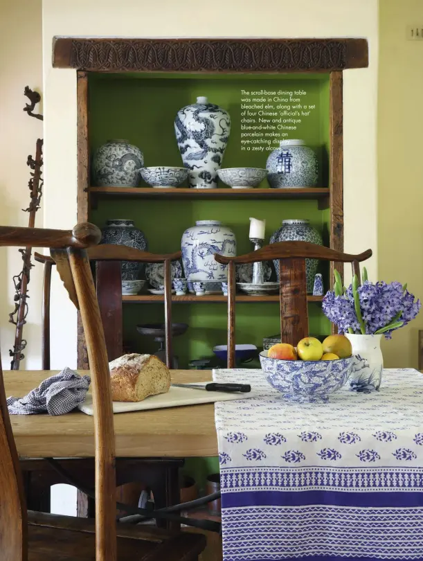  ??  ?? The scroll-base dining table was made in China from bleached elm, along with a set of four Chinese ‘official’s hat’ chairs. New and antique blue-and-white Chinese porcelain makes an eye-catching display in a zesty alcove.