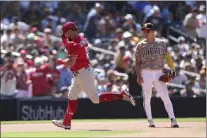  ?? DERRICK TUSKAN — THE ASSOCIATED PRESS ?? Phillies outfielder Kyle Schwarber, left, tips his helmet as he runs the bases in front of San Diego Padres third baseman Ha-Seong Kim after hitting a three-run home run in the seventh inning Sunday in San Diego.