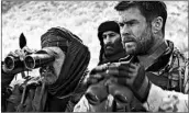  ?? MPAA rating: Running time: WARNER BROS. PICTURES ?? Navid Negahban, left, and Chris Hemsworth, right, star in the film about a Special Forces mission in Afghanista­n.
R (for war violence and language throughout)
2:09