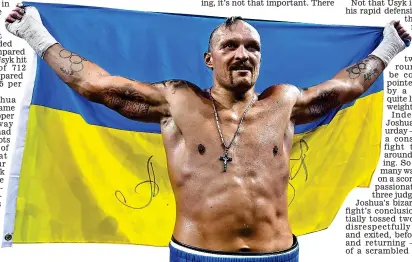 ?? ?? Standard bearer: proud Usyk with the Ukraine flag