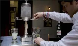  ?? BLOOMBERG ?? A barman releases drops of chilled water from a fountain into a pontarlier glass of absinthe in the bar area at Pernod Ricard SA's absinthe distillery in Thuir, France.