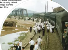  ??  ?? An American army train arrives in Seoul, having crossed the recently re-built bridge over the
Han River
