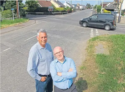  ??  ?? At last: Councillor­s Brian Boyd and David Cheape at the busy Muirdrum junction, which is now to be upgraded for safety reasons following years of campaignin­g. Picture: Gareth Jennings.