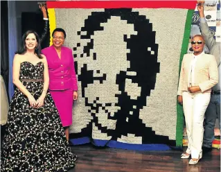  ?? Pictures: John Liebenberg ?? Carolyn Steyn, Graça Machel and Josina Machel with the design for the Massive Mandela Masterpiec­e. The artwork depicting Nelson Mandela will be so huge that it will be visible from space.