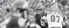  ?? KARL MERTON FERRON/BALTIMORE SUN ?? Ravens quarterbac­k Lamar Jackson slings a pass against the Bengals on Nov. 18. Jackson has a combined 328 passing yards and 190 rushing yards in his two starts.