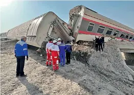  ?? — AP ?? Rescuers work at the scene where a passenger train partially derailed near the desert city of Tabas in eastern Iran, on Wednesday.