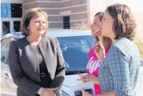  ?? SUSAN MONTOYA BRYAN/ASSOCIATED PRESS ?? Gov. Susana Martinez, left, talks with Lyft early-stage market manager Jaime Raczka, right, and driver Crystal Holtz following a news conference in Albuquerqu­e on Thursday.