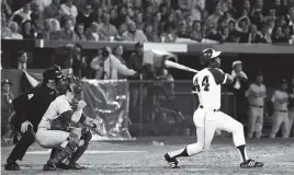  ?? AP ?? Henry Aaron connects for his 715th home run, breaking Babe Ruth’s record, off Dodgers pitcher Al Downing on April 8, 1974 at Atlanta-Fulton County Stadium.