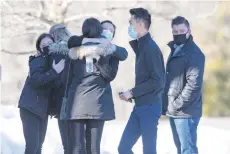  ?? RICK KINTZEL/THE MORNING CALL ?? People embrace Sunday afternoon at the entrance of Billera Hall at DeSales University before a private prayer service after two DeSales graduates and one student were killed in a fiery crash Saturday night in Upper Saucon.