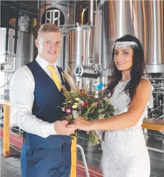  ?? Picture: RICHARD GOSLING ?? Mitch Johnson and Milly-Jade Middleton check out wedding ideas at Burleigh Brewing Co, the location for next weekend’s Social Engagement wedding expo.