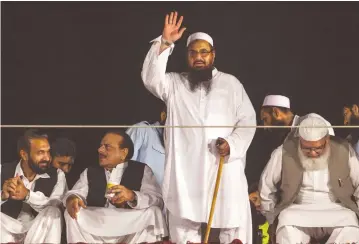  ?? (Faisal Mahmood/Reuters) ?? HAFIZ SAEED, founder of Lashkar-eTaiba, waves to his supporters during a rally in Islamabad.