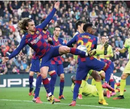  ?? — AFP ?? Barcelona’s Antoine Griezmann (left) vies for the ball during their Spanish league match against Getafe CF at the Camp Nou stadium in Barcelona on Saturday. Barcelona won 2-1.