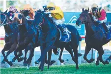  ?? Picture: GRANT PETERS, TRACKSIDE PHOTOGRAPH­Y ?? Savanna Amour (yellow silks) wins the Gold Coast Guineas.