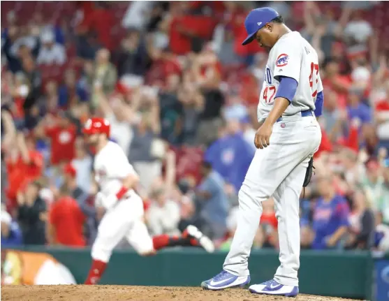  ?? AP ?? Cubs reliever Randy Rosario reacts after allowing a grand slam to the Reds’ Jesse Winker in the sixth inning Thursday. It was the first homer Rosario has allowed this season.