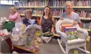  ?? BOB KEELER — MEDIANEWS GROUP ?? From left, Elaine Portock, Wendy Leshinskie, Danielle Mazza and Suzi Leonard stand with baskets that will be in the silent auction at the Indian Valley Public Library’s Aug. 17 Dinner in White at Souderton Community Park.