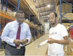  ?? ?? David Williams (right) and Cecil Foster discuss a planned delivery.