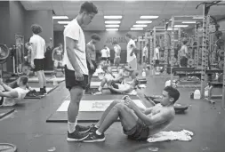  ??  ?? Desert Ridge football players Avantae Barrett, right, and Josiah Kidd work out at the school in Mesa on July 22.