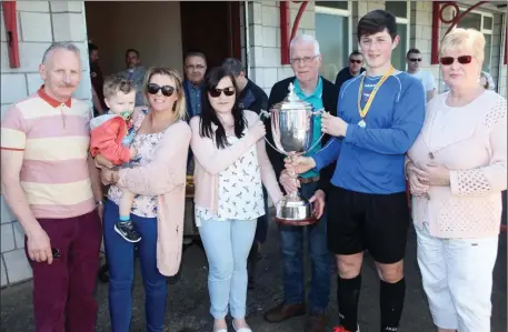  ??  ?? Champions: Adam Devaney, Merville United captain is presented with the Robert Cawley Memorial Cup at McSharry Park on Sunday. Also pictured, from left: Michael O’Donnell, Rachel Cawley with her son Max, Stephaine Callaghan, Val Cawley and Marie...