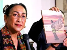  ??  ?? Sukmawati has her book shown as she talks to reporters in Jakarta, Indonesia. — Reuters photo