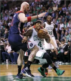  ?? CHARLES KRUPA — THE ASSOCIATED PRESS ?? Boston’s Isaiah Thomas (4) drives to the basket against Washington’s Marcin Gortat, left, during the first quarter in Boston, Tuesday.