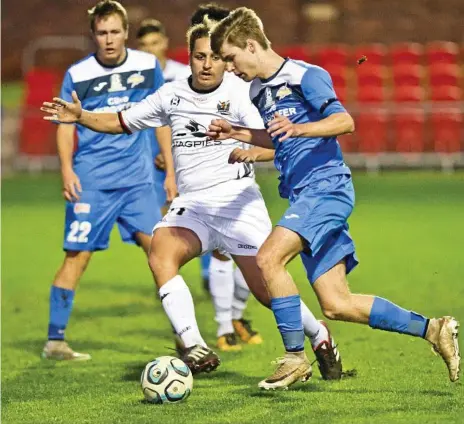  ?? Photo: Nev Madsen ?? IN CONTROL: South West Queensland Thunder midfielder Daniel Weber (right) eases past Magpies Crusaders FC player Ezra Kennell during their NPLQ clash at Toowoomba’s Clive Berghofer Stadium on Saturday. The match finished in a 1-1 draw.