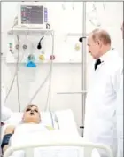  ?? HAGBERG/AFP LARS ?? Russian President Vladimir Putin visits people injured in a fire at a shopping centre, at a hospital in Kemerovo, on Tuesday. Putin has promised a transparen­t investigat­ion into the deadly blaze, following what he called ‘criminal negligence’.