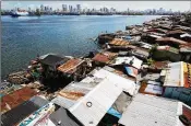  ?? SEONG JOON CHO / BLOOMBERG 2015 ?? Slum housing stands along the shoreline in Manila, Philippine­s, across the bay from more prosperous areas of the capital. A new ID plan may help many of the poorest residents.