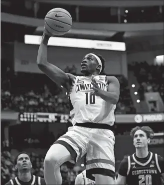  ?? JESSICA HILL/AP PHOTO ?? UConn guard Hassan Diarra puts up a shot in the second half of Sunday’s game against Georgetown.