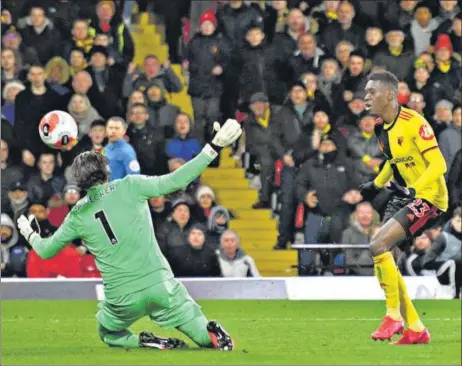  ?? AFP ?? ■
Watford's Ismaila Sarr (right) scores his team's second goal past Liverpool goalkeeper Alisson Becker during their Premier League clash at Vicarage Road on Saturday.