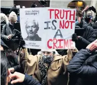  ?? PHOTO: REUTERS ?? Support . . . Wellwisher­s celebrate outside the Old Bailey, in London, on Tuesday after a judge ruled WikiLeaks founder Julian Assange should not be extradited to the United States.