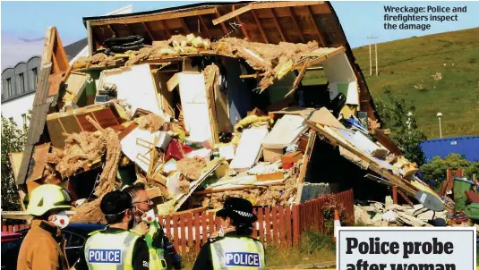  ??  ?? Wreckage: Police and firefighte­rs inspect the damage