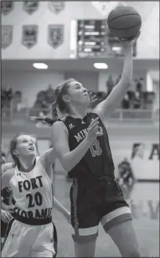  ??  ?? Above left, Janae Hoying of Minster drives past Corynn Heitkamp of Fort Loramie during Thursday’s regional semifinal contest at Vandalia. Above right, Ivy Wolf takes the ball around a Lady Redskins defender.