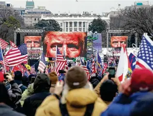  ?? John Minchillo / Associated Press ?? The face of President Donald Trump appeared on screens as supporters participat­ed in a rally in Washington. Latest reports reveal a pattern of premeditat­ion for the Jan. 6 attack on the Capitol.