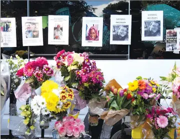  ??  ?? Flowers are placed in front of missing person posters near The Grenfell Tower block. — Reuters photo