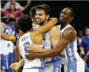  ?? Kevin C. Cox / Getty Images ?? North Carolina’s Luke Maye was the center of his teammates’ attention after making the game-winner.