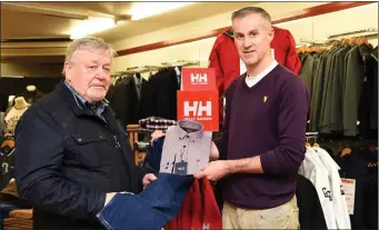  ??  ?? Sean Hussey (right) helping customer Hugo Speytevroo­dt of The Pantry Health Food Store to purchase Tricot Marine Knitwear and shirt and Mustang jeans at Quill’s Kenmare.