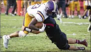  ?? CONTRIBUTE­D BY JEFF GILBERT ?? Butler receiver Bryant Johnson is tackled by a Tecumseh defender after a reception Friday. Johnson had eight receptions for 99 yards and two touchdowns to help the Aviators to a 49-28 victory.