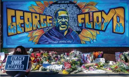  ?? Photograph: Kerem Yucel/AFP/Getty Images ?? Flowers, signs and balloons are left at a makeshift memorial to George Floyd near the spot where he was murdered by policeman Derek Chauvin.