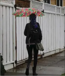  ?? SHAE HAMMOND — STAFF PHOTOGRAPH­ER ?? A woman walks with an umbrella in San Jose on Saturday.