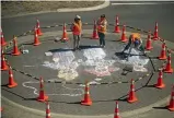  ?? PHOTO: DAVID UNWIN/STUFF ?? Chalk drawing on the roundabout outside the Square Edge building are Hem Woollaston, Kate Wilson-bryant and Lisa Ross.