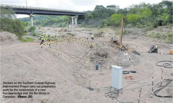  ?? (Photos: JIS) ?? Workers on the Southern Coastal Highway Improvemen­t Project carry out preparator­y work for the constructi­on of a new four-lane bridge over the Rio Minho in Clarendon.