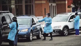  ?? Erik Trautmann / Hearst Connecticu­t Media ?? Day Street Community Health Center staff conduct drive-thru coronaviru­s testing Wednesday at Brien McMahon High School in Norwalk.