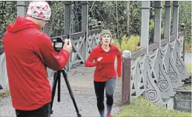  ?? CLIFFORD SKARSTEDT EXAMINER ?? Pollinator advocate Carlotta James runs past filmmaker Rodney Fuentes on Friday at Jackson Park. James and Fuentes are part of a team planning the Monarch Ultra, a 4,200-kilometre relay run.
