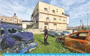  ?? ?? Palestinia­n mechanic and garage owner Motaz Qassrawi shows cars wrecked during an attack by Zionist settlers in Huwara.