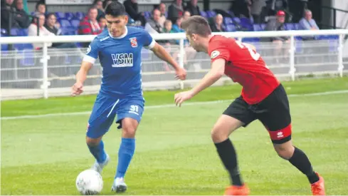  ?? Picture: Andre Pepper ?? Bangor City’s Anderson Cayola takes on Prestatyn defender Zebb Edwards in last Friday’s Welsh Premier League derby at the Bangor University Stadium.